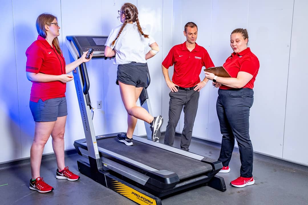 Faculty and students at a treadmill